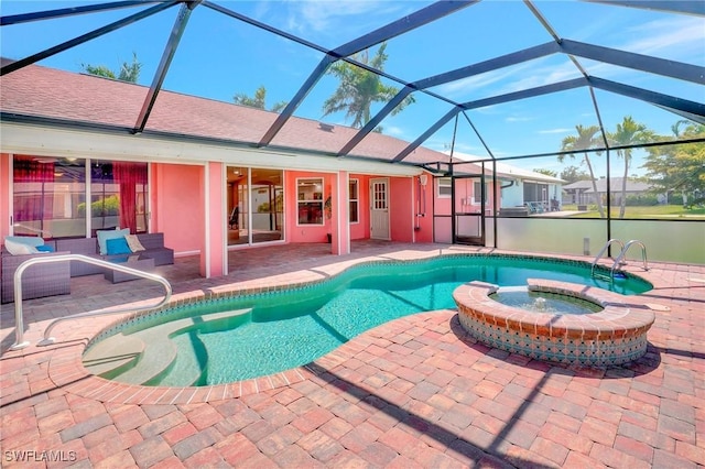 view of swimming pool featuring a patio area, glass enclosure, and a pool with connected hot tub
