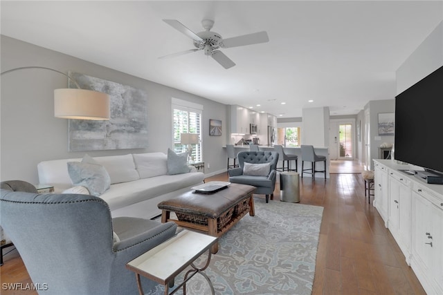 living room featuring ceiling fan and wood finished floors