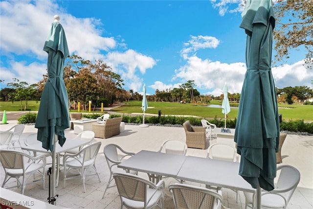 view of patio / terrace featuring view of golf course and outdoor dining area