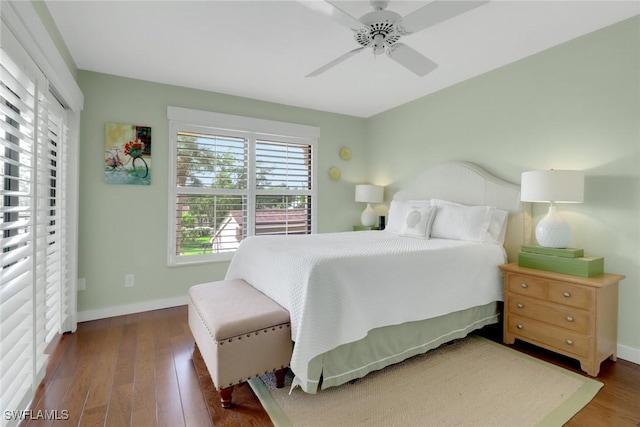 bedroom with wood finished floors, baseboards, and a ceiling fan