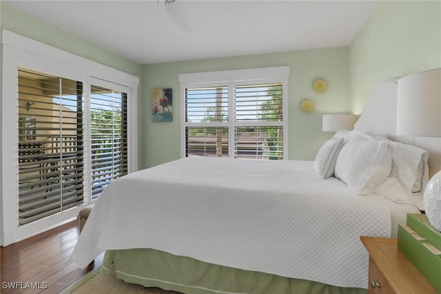 bedroom with hardwood / wood-style floors and ceiling fan
