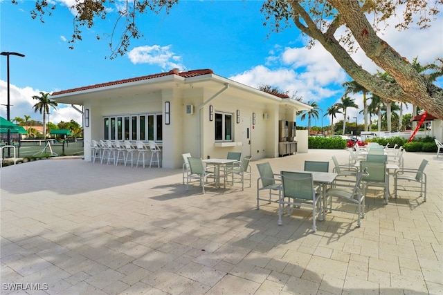 view of patio with outdoor dining space and fence