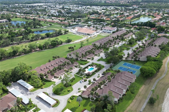 aerial overview of property's location with nearby suburban area, a nearby body of water, and a golf course