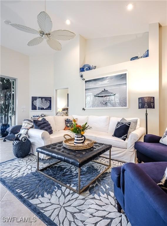 tiled living room featuring ceiling fan