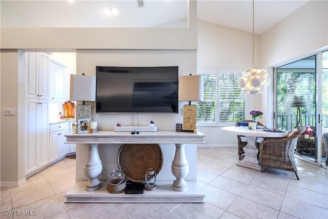 living room featuring lofted ceiling, light tile patterned floors, and baseboards