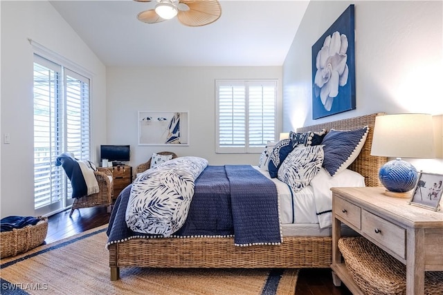 bedroom featuring lofted ceiling, multiple windows, wood finished floors, and a ceiling fan