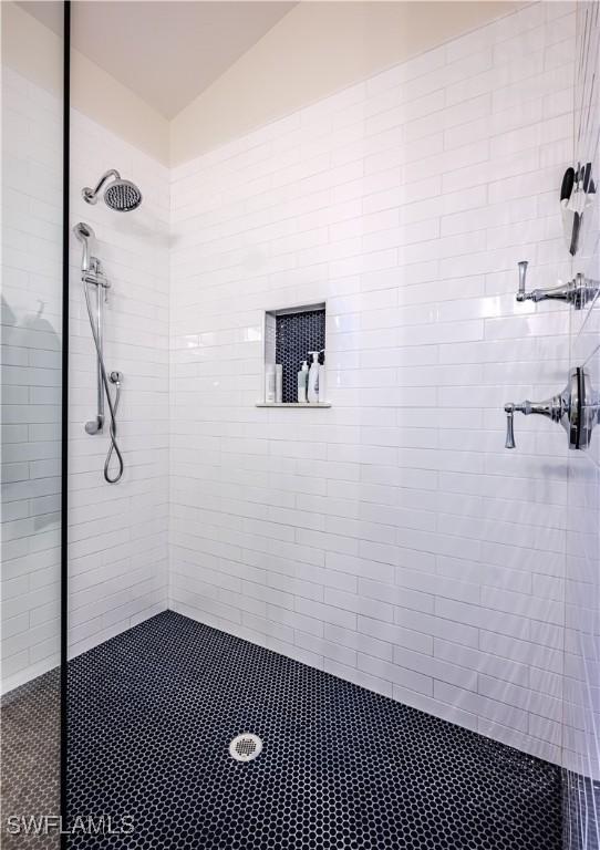 full bath with a tile shower