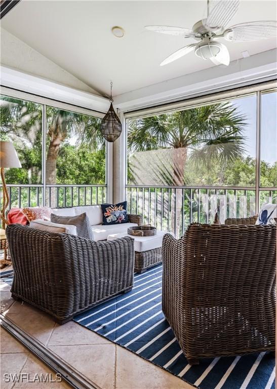 sunroom with an outdoor hangout area, a ceiling fan, and vaulted ceiling