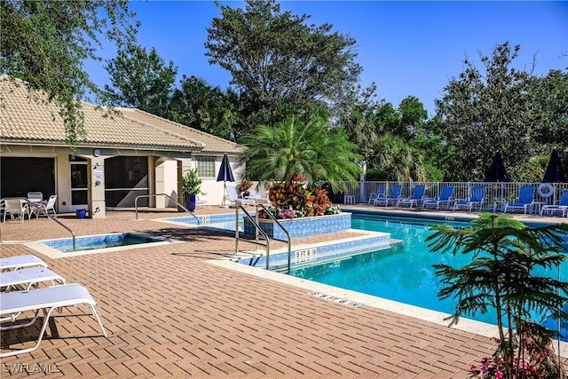 community pool featuring a patio and fence