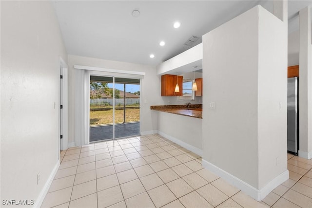 interior space featuring visible vents, baseboards, light tile patterned flooring, and recessed lighting
