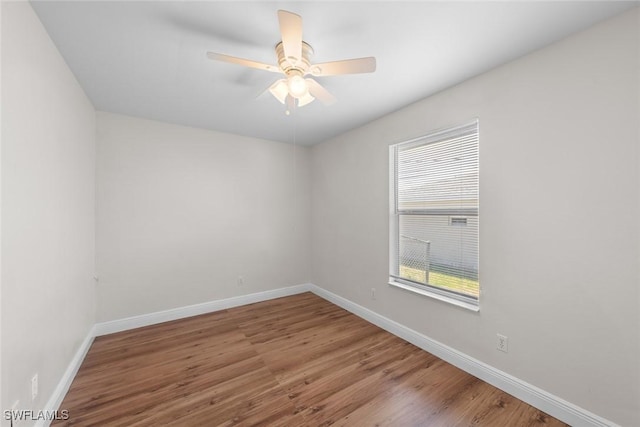 unfurnished room with baseboards, a ceiling fan, and wood finished floors