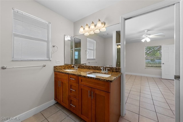 bathroom featuring a sink, tile patterned flooring, and baseboards