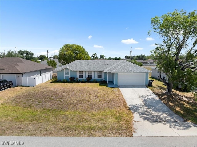 ranch-style home with an attached garage, driveway, fence, and a front yard