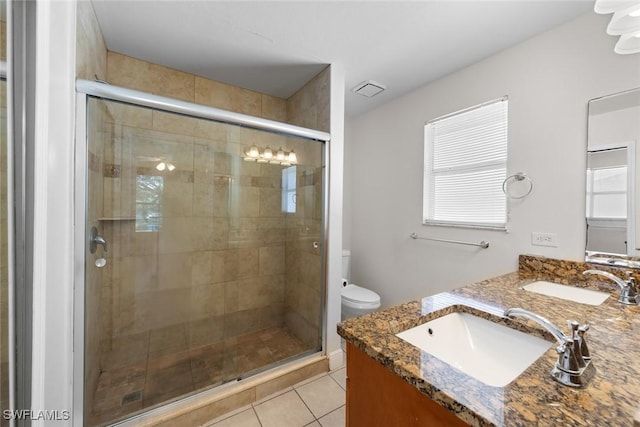 bathroom featuring a shower stall, tile patterned floors, and a sink
