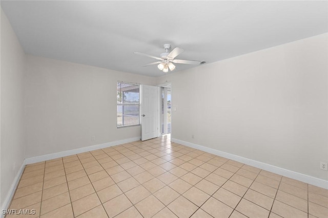 unfurnished room with ceiling fan and baseboards