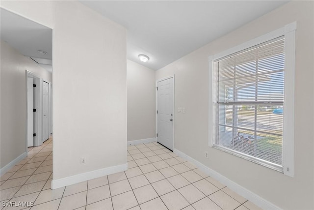 foyer entrance featuring light tile patterned floors and baseboards