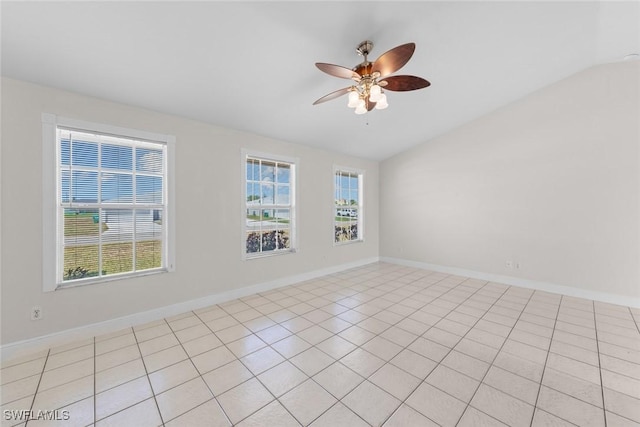 empty room with a ceiling fan, plenty of natural light, baseboards, and lofted ceiling