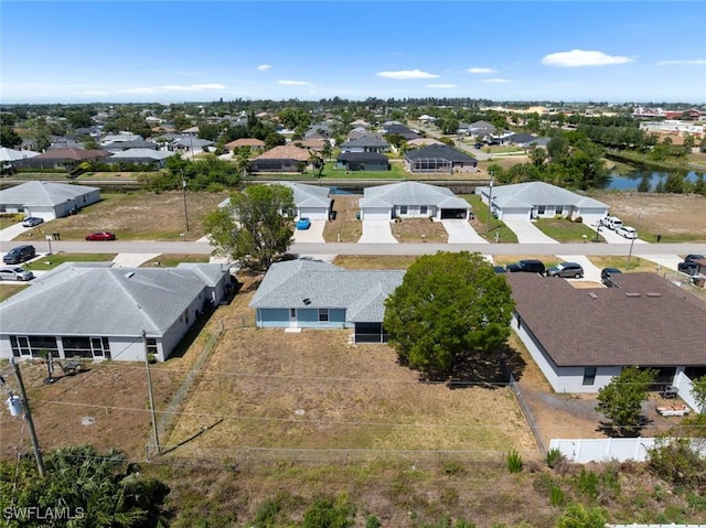 birds eye view of property with a water view and a residential view