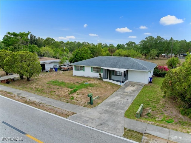 single story home with an attached garage, driveway, and a front yard