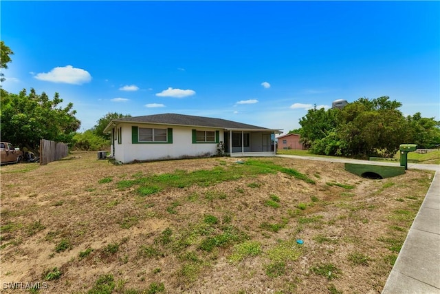 back of house with a sunroom and fence