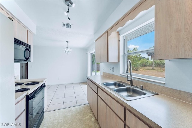 kitchen with black microwave, range with electric cooktop, a sink, light brown cabinetry, and light countertops