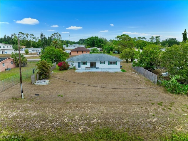 back of property featuring a fenced backyard and a patio