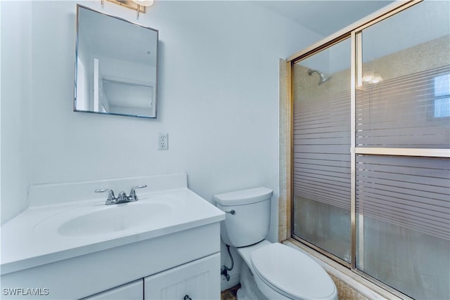 full bathroom featuring an enclosed shower, toilet, and vanity