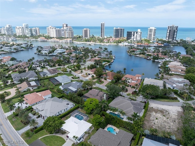 aerial view of property's location featuring a nearby body of water and nearby urban area