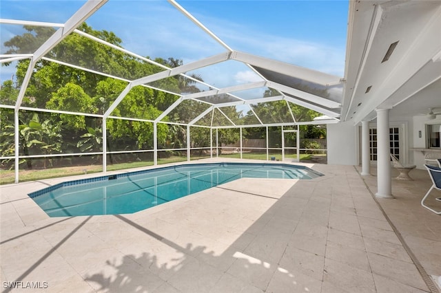 outdoor pool featuring a patio, a fenced backyard, and a lanai