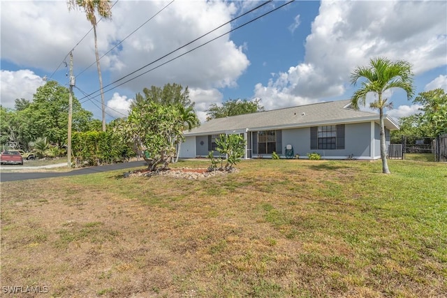 5295 17th Ave SW, Naples, FL 34116 - rear view of house with fence and a lawn