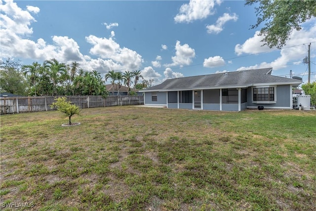 5295 17th Ave SW, Naples, FL 34116 - back of property featuring a fenced backyard, a sunroom, and a lawn