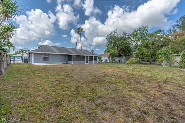 5295 17th Ave SW, Naples, FL 34116 - back of house with a yard, a sunroom, and fence