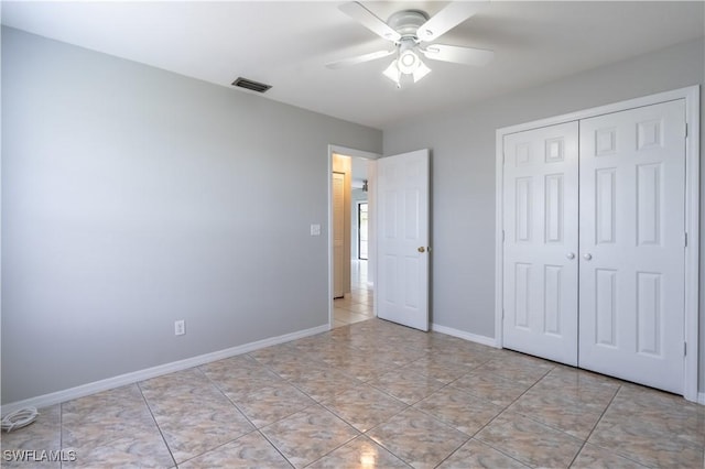 5295 17th Ave SW, Naples, FL 34116 - unfurnished bedroom featuring a closet, visible vents, a ceiling fan, light tile patterned floors, and baseboards