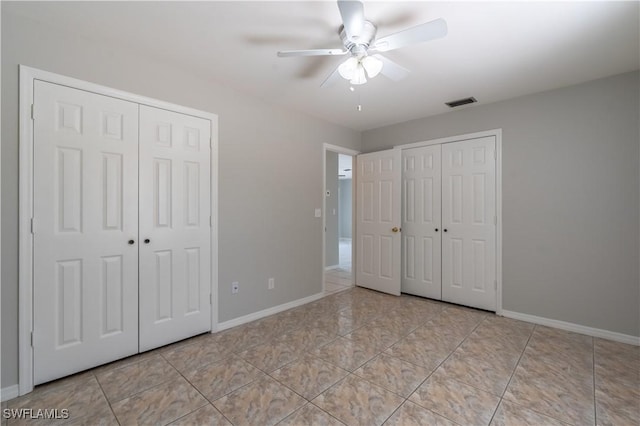 5295 17th Ave SW, Naples, FL 34116 - unfurnished bedroom featuring tile patterned flooring, baseboards, a ceiling fan, and visible vents