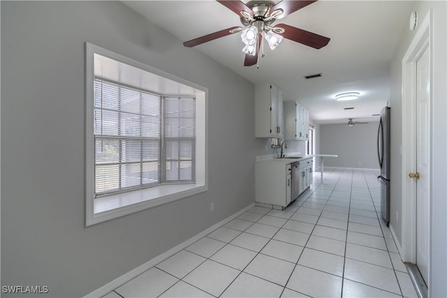 5295 17th Ave SW, Naples, FL 34116 - interior space with a ceiling fan, a sink, stainless steel appliances, a healthy amount of sunlight, and visible vents