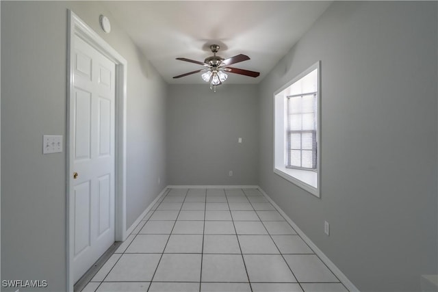 5295 17th Ave SW, Naples, FL 34116 - empty room with light tile patterned floors, baseboards, and a ceiling fan