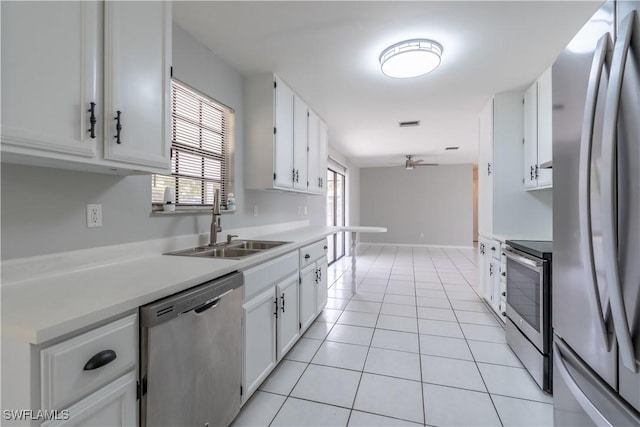 5295 17th Ave SW, Naples, FL 34116 - kitchen with light countertops, white cabinetry, stainless steel appliances, and a sink