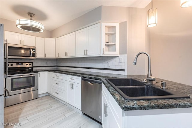 kitchen featuring a sink, white cabinets, and appliances with stainless steel finishes
