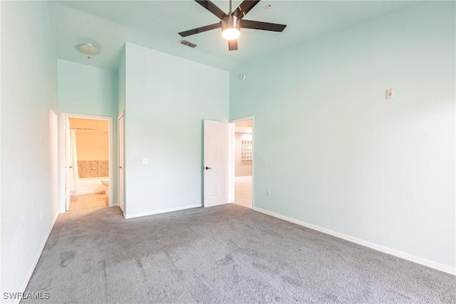 unfurnished bedroom with carpet, a ceiling fan, high vaulted ceiling, visible vents, and baseboards
