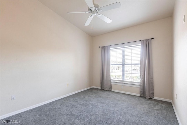 carpeted empty room featuring baseboards, lofted ceiling, and ceiling fan