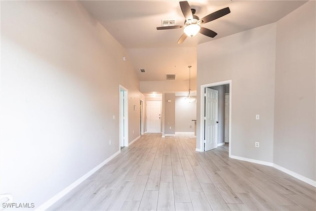 empty room featuring ceiling fan, baseboards, light wood-type flooring, and visible vents