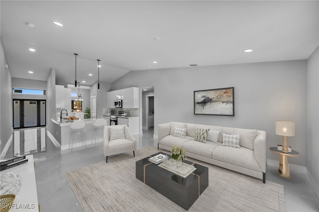 living area with vaulted ceiling, baseboards, and recessed lighting