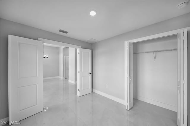 unfurnished bedroom featuring a closet, baseboards, and visible vents