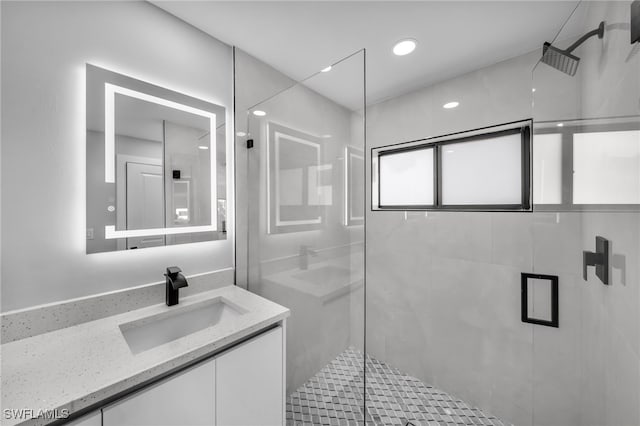 bathroom featuring a stall shower and vanity