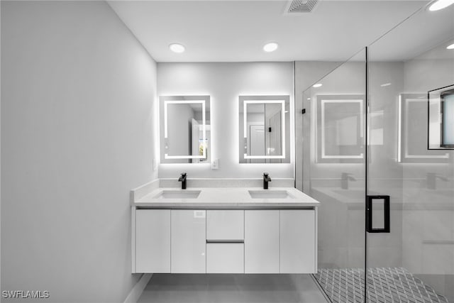 bathroom with a shower stall, visible vents, a sink, and double vanity