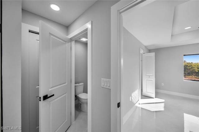 bathroom with toilet, baseboards, and recessed lighting