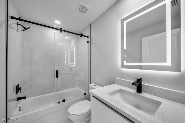 bathroom with toilet, vanity, visible vents, recessed lighting, and shower / bath combination with glass door