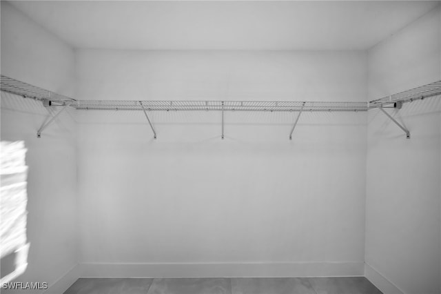 walk in closet featuring tile patterned flooring