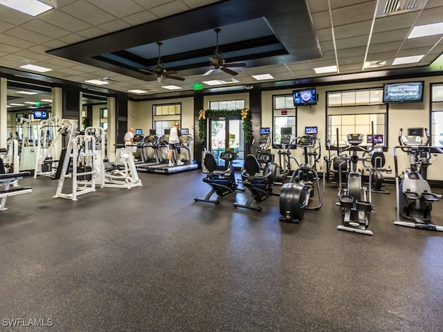 exercise room featuring a ceiling fan and a drop ceiling