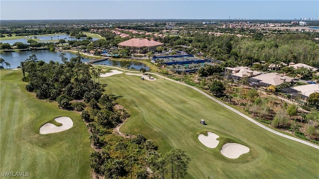 view of property location with a local golf course, a large body of water, nearby suburban area, and a tree filled landscape